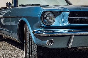 front of a blue classic convertible